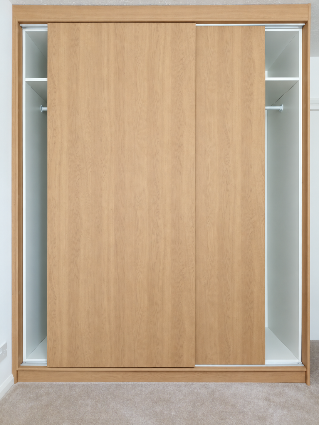 Fitted wardrobe interior with clothes